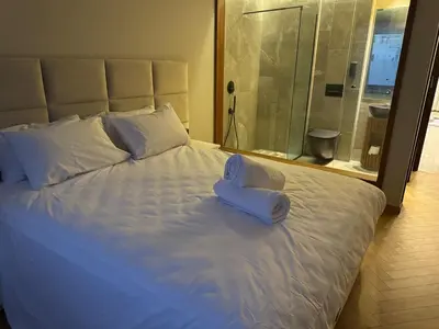 a large white bed with a pair of towels on it at HERBA Studio - Cozy Space with an Unobstructed View in Bourgogne in Casablanca