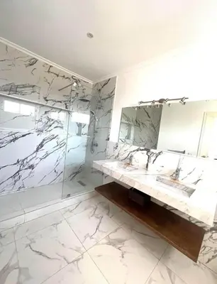 a bathroom with two sinks and a mirror at Villa Sophia in Dar Bouazza