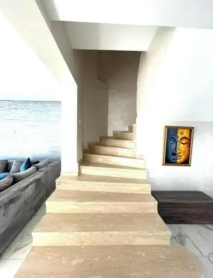 a staircase in a house with a painting on the wall at Villa Sophia in Dar Bouazza