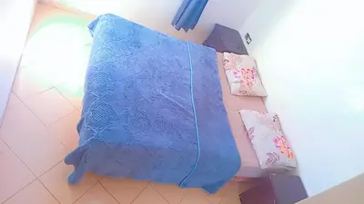 a blue blanket sitting on a bed with two pillows at Tranquilité au rendez-vous in Casablanca