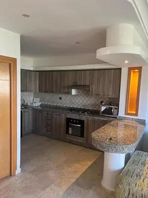 a kitchen with a table and a counter top at seaside entire villa with pool view in Casablanca
