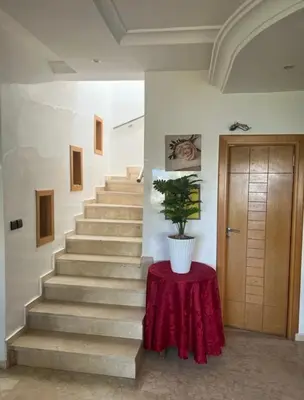 a staircase with a table with a potted plant on it at seaside entire villa with pool view in Casablanca