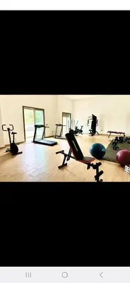 a gym with several treadmills and exercise bikes at appartement résidence garden paradise plage bouznika in Bouznika