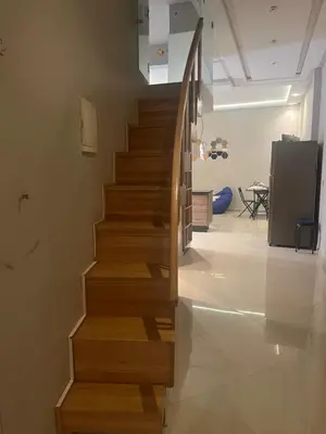 a wooden staircase in a living room with at Toute commodité in Casablanca