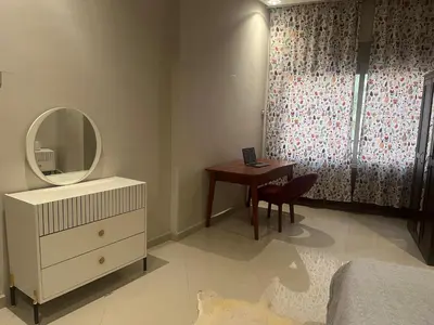 a bedroom with a dressing table and a mirror at Toute commodité in Casablanca
