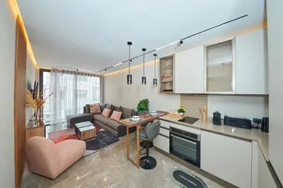 a kitchen and living room with a couch and a table at Marilla Studio - Elegant & Peaceful Stay in Bourgogne, Steps from Mohamed V Stadium in Casablanca