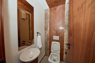 a small bathroom with a toilet and a sink at Marilla Studio - Elegant & Peaceful Stay in Bourgogne, Steps from Mohamed V Stadium in Casablanca