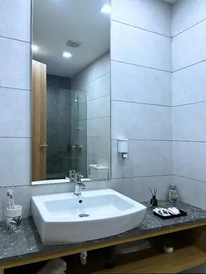 a bathroom with a white sink and a mirror at Premium Studio Central Casablanca in Casablanca