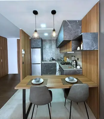 a kitchen with a wooden table and two chairs at Premium Studio Central Casablanca in Casablanca