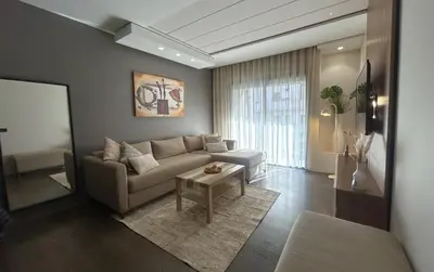 a living room with a couch and a table at Premium Studio Central Casablanca in Casablanca