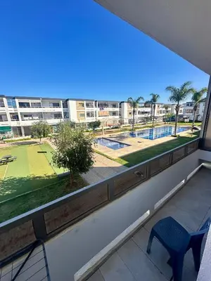 a room with a large window with a view of a park at Appartement Marbella beach in Mansouria