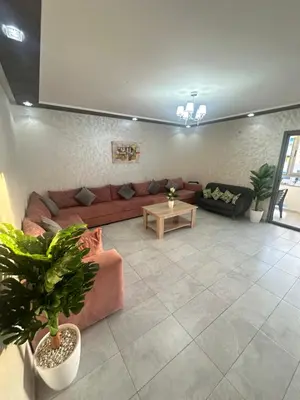 a living room with a couch and a table at Appartement Marbella beach in Mansouria