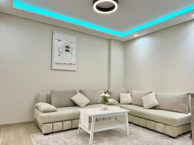 a living room with a couch and a table at Modern Comfort Studio, la corniche in Mohammedia