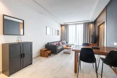 a living room with a couch and a table at APGCI-Elegant studio sur Ferme bretonne in Casablanca