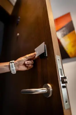 a hand opening a wooden door with a handle at APGCI-Elegant studio sur Ferme bretonne in Casablanca
