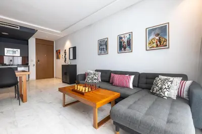 a living room with a couch and a table at APGCI-Elegant studio sur Ferme bretonne in Casablanca