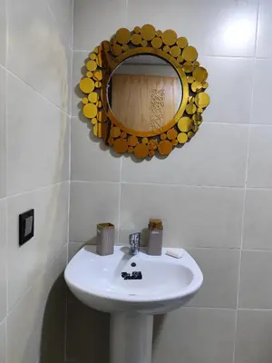 a bathroom with a sink and a mirror on the wall at Évasion Marine & piscine 3 chambres in Bouznika