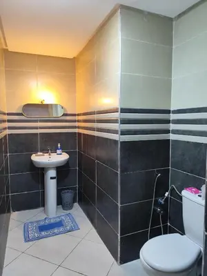 a bathroom with a toilet and a sink at Évasion Marine & piscine 3 chambres in Bouznika