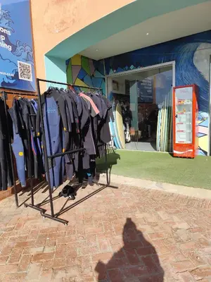 a rack of shirts in front of a store at Évasion Marine & piscine 3 chambres in Bouznika