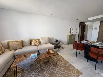 a living room with a couch and a table at Cosy Studio at B-Living Casa Port Ideal for Business & City Trips with Open View Heart Of Casablanca in Casablanca