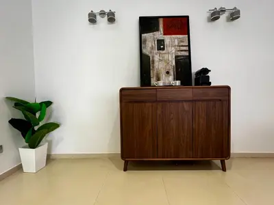 a wooden cabinet in a room with a mirror on the wall at Urban Chic 2BR - Prestigia near stadium in Rabat