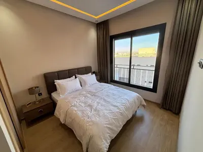 a bedroom with a bed and a large window at Studio moderne avec Fibre Optique, 55po TV et CVC in Casablanca