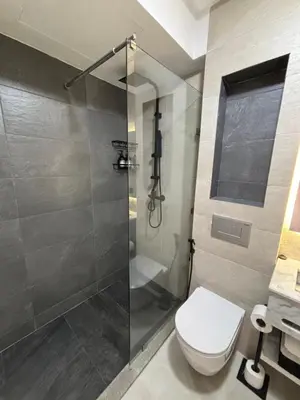 a bathroom with a toilet and a glass shower at Studio moderne avec Fibre Optique, 55po TV et CVC in Casablanca