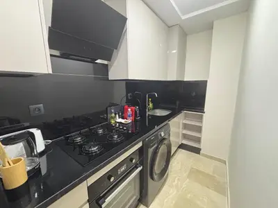 a small kitchen with a stove and a sink at Studio moderne avec Fibre Optique, 55po TV et CVC in Casablanca