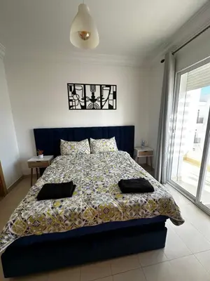 a bedroom with a bed with two pillows on it at Métropole parc Manesmane in Mohammedia