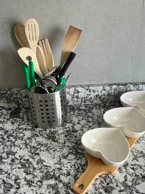 a container of kitchen utensils sitting on a counter at Métropole parc Manesmane in Mohammedia