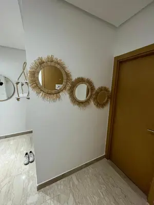 two mirrors on a wall next to a door at Métropole parc Manesmane in Mohammedia