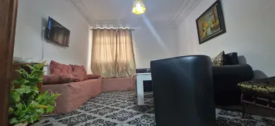 a living room with a couch and a chair at Appartement Océan in Rabat