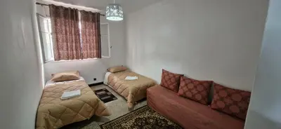 a living room with a couch and a bed at Appartement Océan in Rabat