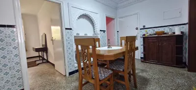 a kitchen with a table and chairs in a room at Appartement Océan in Rabat