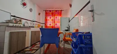 a kitchen with blue chairs and a table at Appartement Océan in Rabat