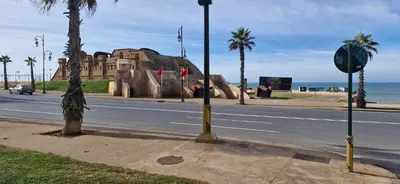 a street with a building on the side of the road at Appartement Océan in Rabat