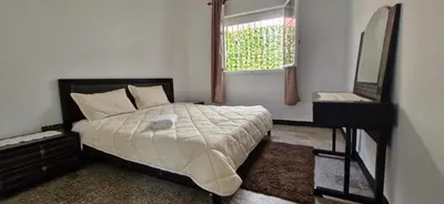 a bedroom with a bed and a mirror and a table at Appartement Océan in Rabat