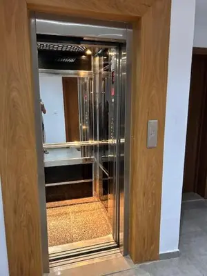 a glass door to a kitchen with a refrigerator at Modern Apt with sea view and access to the beach in El Harhoura