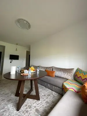 a living room with a couch and a table at Appartement à Skhirat plage in Skhirat
