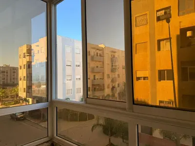 a group of windows with a view of a building at Appartement à Skhirat plage in Skhirat