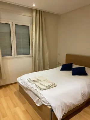 a bedroom with a bed with two towels on it at Joli Appartement 2 pièces in Rabat