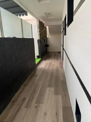an empty hallway of an office with wood floors at Joli Appartement 2 pièces in Rabat