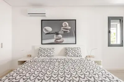 a bedroom with a bed and a picture on the wall at La perle de Harhoura Piscine-Océan -Terrain Rabat in Temara