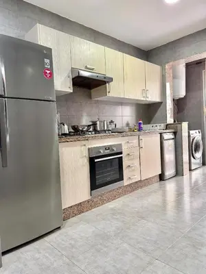 a kitchen with a stainless steel refrigerator and appliances at La perle de Harhoura Piscine-Océan -Terrain Rabat in Temara