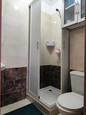 a bathroom with a shower and a toilet at Eco Gare centre 2 chambres in Bouznika