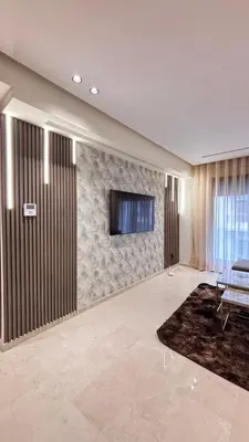 a living room with a tv on a wall at Hammersmith 11 in Casablanca