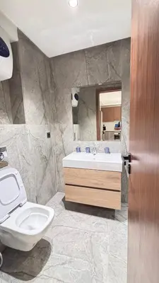 a bathroom with a sink and a toilet and a mirror at Hammersmith 11 in Casablanca
