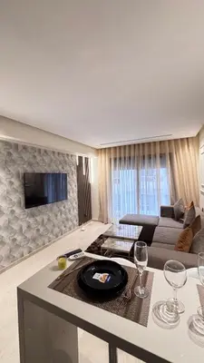 a living room with a couch and a table with wine glasses at Hammersmith 11 in Casablanca