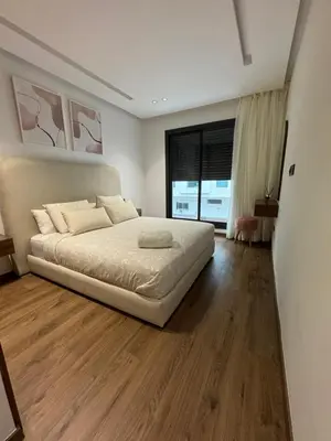 a bedroom with a bed and a large window at Studio à louer in Casablanca
