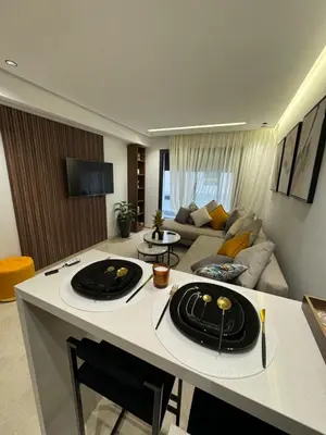 a kitchen and living room with a couch at Studio à louer in Casablanca